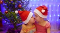 Two Sisters Embrace And Kiss At Christmas Party. In The Background, Lights And