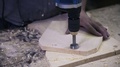 A Worker Is Processing A Hole In A Wood By Using A Power Hole Saw.