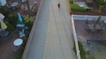 Aerial Drone Uav View Of A Boy Playing Soccer Football On A Walk Street In A Nei