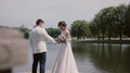 Loving Couple On A Quay. Beautiful Bride Shows Her Wedding Dress, Swirls Around