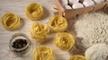 Pasta, Eggs, Oil, Garlic And Flour On Wooden Background