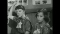 United States, 1961: Two Girls In Scout Uniforms Talking To Teacher.