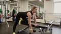 20s Sportive Woman Doing Exercises With Dumbbell On A Bench In Gym Class. Slow