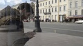 Man Sitting At The Bus Stop And Using The Phone