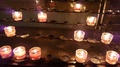 Votive Candles Lit In Some Cathedral And Standing On Some Low Racks