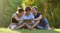 Students Using Tablet Pc On Lawn, Exulting And Laughing- Slow Motion