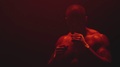 Muscular Black Man Standing On A Foggy Dark Red Background