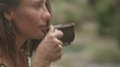 Rested Woman Drinks Cappuccino From The Mug Outdoors