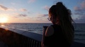 Young Girl With Smartphone Against Beautiful Sunset Over Mediterranean Sea In