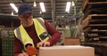 Worker Packing Box In Warehouse