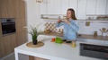 Charming Woman Cooks Phone In Hands And Composes Composition Of Vegetables For