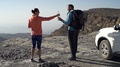 Young Couple Trekking, Taking Break And Drinking Water Near Canyon