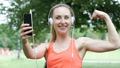 Sporty Girl Looks Happy While Having A Videocall In The Park, Steadycam Shot