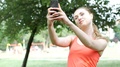 Sporty Girl Looks Happy While Doing Selfies On Smartphone In The Park, Steadycam
