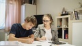 Two Young People Solving A Problem On Paper 4k