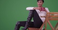 African American Woman In Black Boots Sitting At A Caf Table On Green Screen