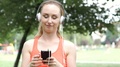 Girl Playing Music On Smartphone During Her Break In Exercises, Steadycam Shot