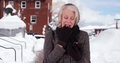 Elder Woman Shivering Outdoors In The Snow Removing Glove To Text On Smart Phone