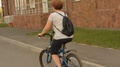 Woman With A Backpack Riding A Bicycle