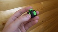 Male Hand Uses A Black And Green Fidget Cube-Antistress