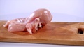 Raw Chicken Fillet And Parsley Falls On A Wooden Board, Slow Motion