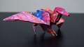 A Man Puts A Finished Origami Dragon On A Table - Closeup