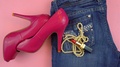 Woman Laying Out Jeans, Pink High Heels, Lipstick And Necklace Overhead On Pi