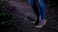 Brunette Girl In Heels And Jeans Dancing At Night In The Woods