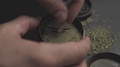 Grinding Cones Of Marijuana With A Grinder Сlose-Up. Weed Buds And Grinder