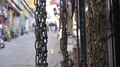 From Chains Hanging To Street With People Walking - Slide - Right To Left