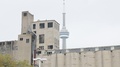 Cn Tower Behind Industrial Buildings - Toronto Canada October 16th 2016