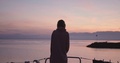 Stylish Young Girl Puts On Hoodie While Watching Sunset Form Yacht.
