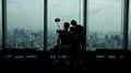 Silhouette Of Group Of Friends Taking Selfie Stick Photos Of Tokyo City Skyline