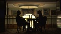 The Silhouettes Of The Loving Couple Hapilly Talking While Sitting At The Table