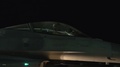 Pilot In Cockpit Of F-16 While Taxiing Out Of Hangar At Night