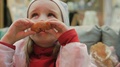 Little Girl Eats Delicious Donuts In The Cafe