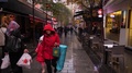 Pov Camera Walk Along Small Side Street In Rain, People On The Way
