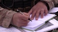 Airman Writing In Notebook