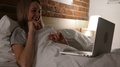 Lying In Bed At Night, Web Video Chat On Laptop By Woman