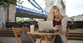 Attractive White Girl In London Uses Laptop And Smartphone Near The Tower Bridge