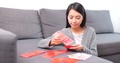Woman Putting Money Into Chinese Red Packet