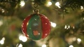 Slider Push In To Red And Green Glass Ball Ornament Hanging On Christmas Tree.