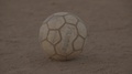 Close Up Kicking An Old Football In Africa - No Grade Prores422