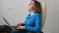 A Woman Sits Behind A Laptop And Composes Something, Looking For Inspiration. In