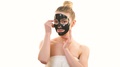 The Happy Woman With A Black Mask Touching A Face On The White Background