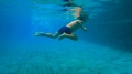 Slowmotion Underwater Shot Of A Little Boy Learns How To Swim In A Pool