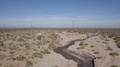 Small Stream Winds Through Desert, Aerial Fly By, Low To Ground