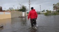 Man Walks Across Flood Waters After Hurricane Maria