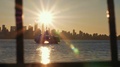 Sunsetting Through City Skyline As Friends In Fishboat Enjoy The Harbor View