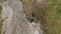 Mountain Trekking, A Young Man Run Along The Stream